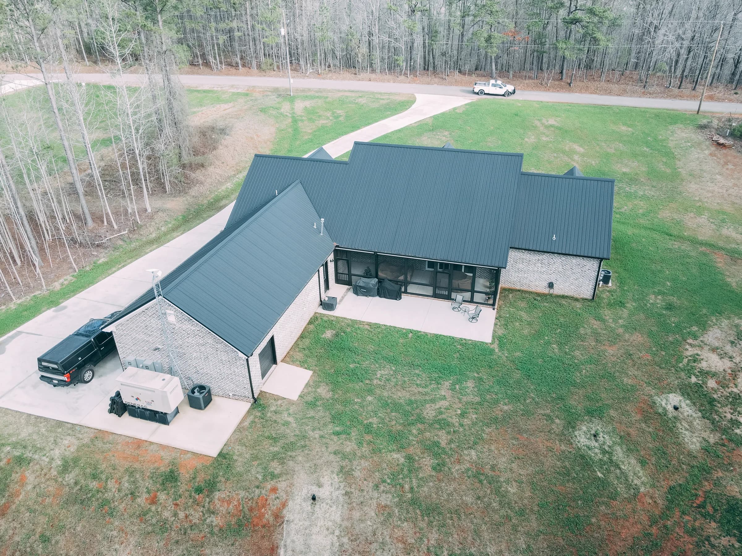 Completed roof replacement by Waterstone Companies showing clean ridge line and precise flashing details